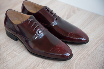 A pair of good beautiful and expensive men's shoes. The concept of success and style. Maroon.