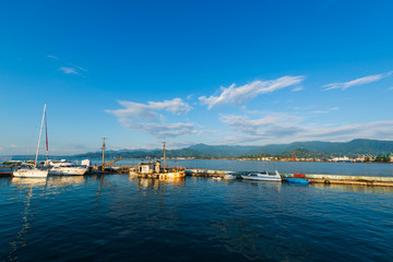 Fototapeta na wymiar Beautiful sunset and small ships in Batumi sea port