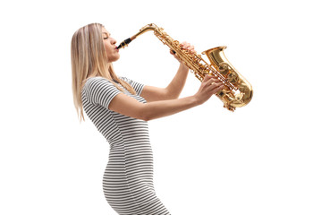 Profile shot of a blond young woman playing a sax