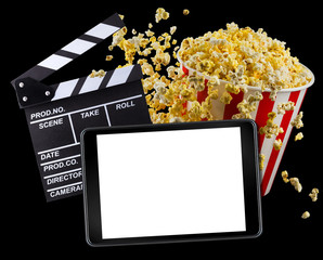 Flying popcorn, film clapper board and phone isolated on black background