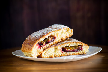 sweet baked homemade plum cake with icing sugar