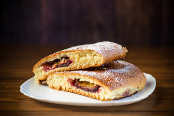 sweet baked homemade plum cake with icing sugar
