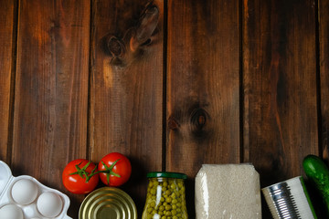 Food donations on a wooden background. Social assistance. Copy space.