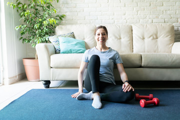 Happy woman exercising at home