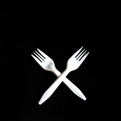 Plastic forks on black background