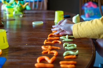 Kindergarten education concept of forming clay numbers to practice counting 