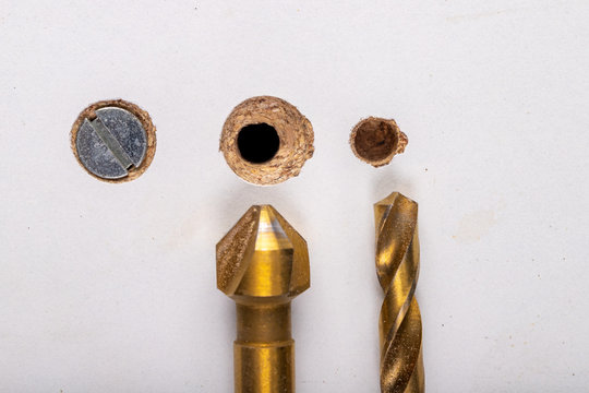 Drilling in a furniture board. Making a hole and countersinking for a metal screw.