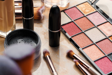 Decorative cosmetics and tools on dressing table in makeup room, close up