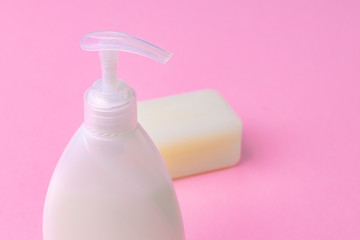 Hand antiseptic disinfection, soap bar on pink paper background. Close up.