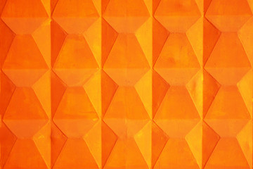 Orange geometric background. Reinforced concrete fence. Fragment.