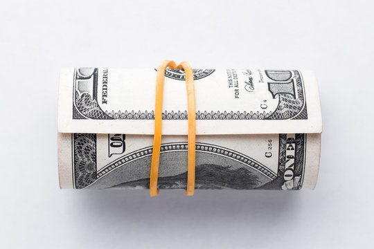 Banknotes are rolled up and tightened with an elastic band