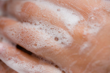 Close-up. Girl carefully washes her hands with an antibacterial soap. The concept of protection from infections and coronavirus