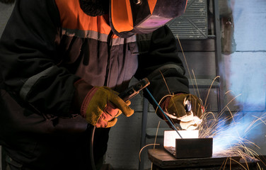 Welders working at the plant produce metal structures