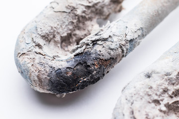 The heating element of the washing machine close-up. The cause of the damage is hard water and limescale. Selective focus