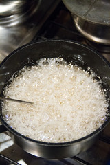 Photo of the process of making strawberry and raspberry jam with black pepper. Making syrup before adding berries. 