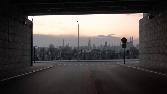 Aerial bridge underpass reveals vast cemetery in New York City suggests victims from coronavirus Covid-19 pandemic epidemic outbreak deaths.