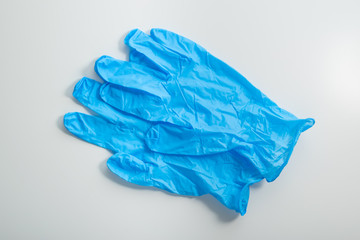 Pair of blue medical gloves on white background top view