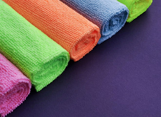 
colored microfiber cloths. purple background.