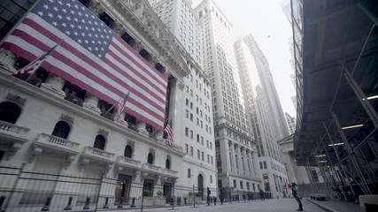 Amazing POV shot of abandoned Wall Street empty streets of New York Manhattan during the Covid-19 coronavirus epidemic outbreak.