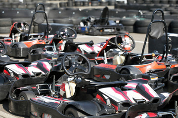 Fototapeta na wymiar Kart cars parked next to track in anticipation of drivers