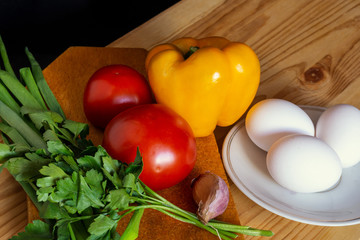 tomatoes sweet peppers eggs and herbs for making shakshuka