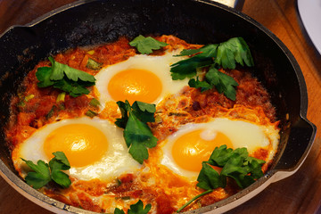 in hot shakshuka tomatoes sweet peppers eggs and herbs