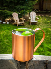 cold beverage with limes in copper mug