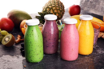 Assortment of fruit smoothies in glass bottles. Fresh organic Smoothie ingredients. Smoothies for health or detox diet food
