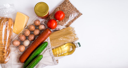 Food delivery, donations. Textile bag with food supplies of the crisis food supply for the period of quarantine isolation on a white background