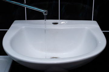 Tap water flows into the sink