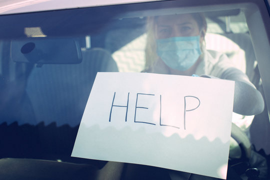COVID-19. Woman mask. Car. Help me. Virus.