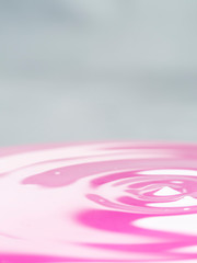 Violet drop of water with black background