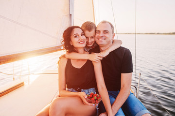 Portrait of Happy family with son resting on a sailing yacht