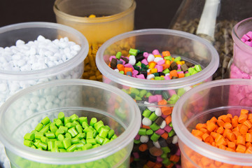 Plastic pellets. Dyes for plastic, polypropylene, polyethylene. Plastic granules in a measuring container and test tubes in the laboratory.