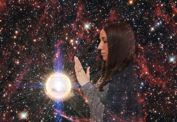 Girl on the background of the starry sky. Magic ball. Paranormal abilities, clairvoyance. Elements of this image are provided by NASA