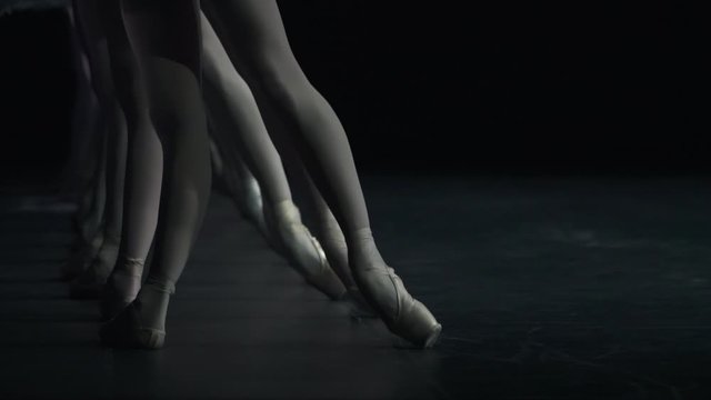 silhouette of women ballerinas legs standing in frozen position. Spbd. performers ballet dancers on stage. concept holding balance, performance, theatre. dancer in pointes