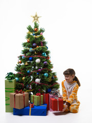 Girl takes out a gift from under the Christmas tree