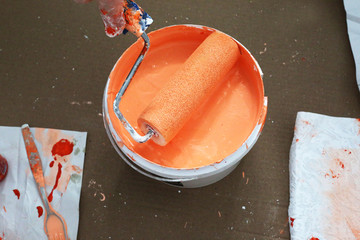 Roller for painting the walls  orange colour.