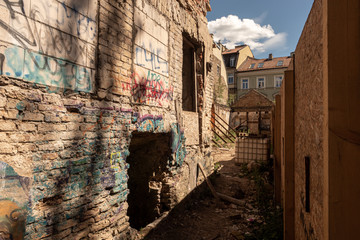 Narrow passage next to a ruined old building