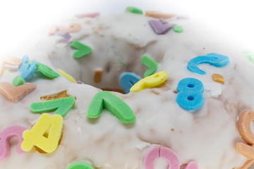 White donut with sprinkles. Food detail. 