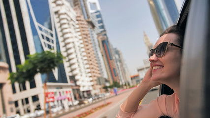 Happy Girl driving a car in Dubai. UAE.