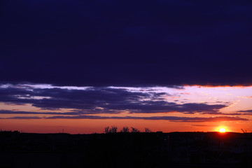  Epic dramatic sunset over the panoramic silhouette of the city    
