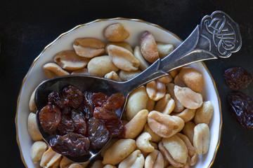 Raisins and roasted peanuts snack closeup