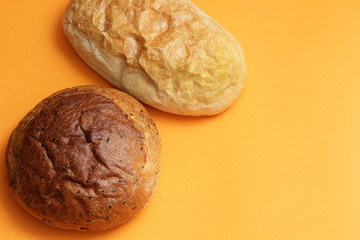 fresh bread with flax and ciabata on an orange background