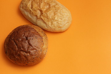 bread with flax and ciabata on an orange background