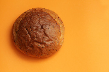 lush rye bread with flax on an orange background