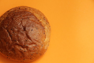 lush rye bread with flax on an orange background
