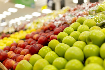 Assortment of fresh fruits at market, blurred background and lights