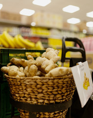 Ginger for sale. Local produce for sale displayed at the market. Organic and bio fresh healthy eating concept. Veggies, vegetables, herbs and spices, price tags