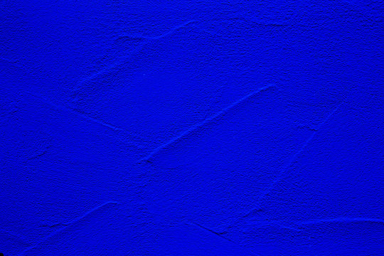 Blue colored abstract wall background with textures of different shades of blue